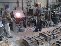 Fence -- Swiss Foundry -- furnace with metal for fence elements. Owner Vojislav Veljko on left - September 28, 2010