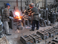 Fence -- Swiss Foundry -- pouring metal for fence elements. Owner Vojislav Veljko on left - September 28, 2010