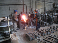 Fence -- Swiss Foundry -- pouring metal for fence elements. Owner Vojislav Veljko on left.