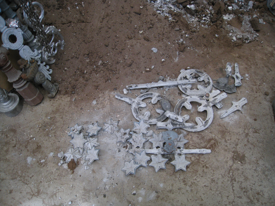 Fence -- Swiss Foundry -- newly extracted fence elements (here, circles, spears, and stars) from cooling molds.