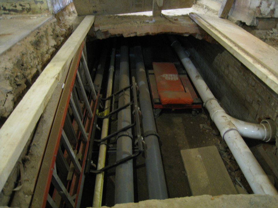 Ground Floor -- original brick chase for ventilation, located under the main corridor running east and west, now being used as a utility chase.