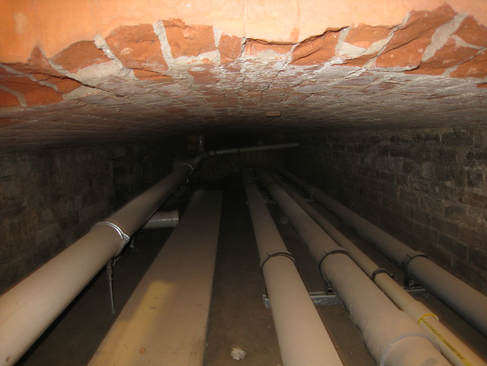 Ground Floor -- original brick chase for ventilation, located under the main corridor running east and west, now being used as a utility chase.