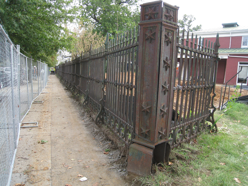 Fence--Removal of cement from bottom of fence on Pennsylvania Ave. side (northwest corner of fence)