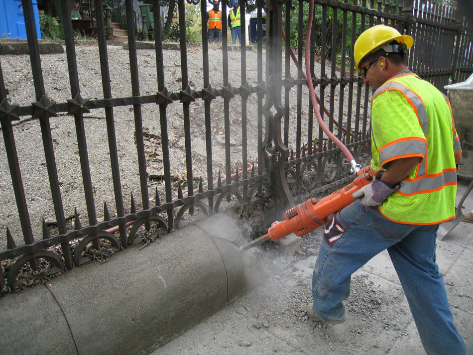 Fence--Removal of cement from bottom of fence on Pennsylvania Ave. side