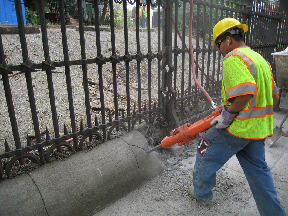 Fence--Removal of cement from bottom of fence on Pennsylvania Ave. side