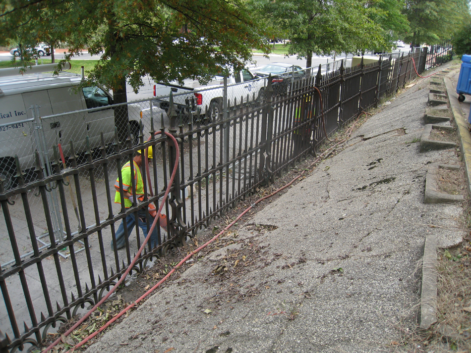 Fence--Removal of cement from bottom of fence on Pennsylvania Ave. side