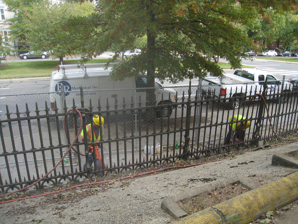 Fence--Removal of cement from bottom of fence on Pennsylvania Ave. side