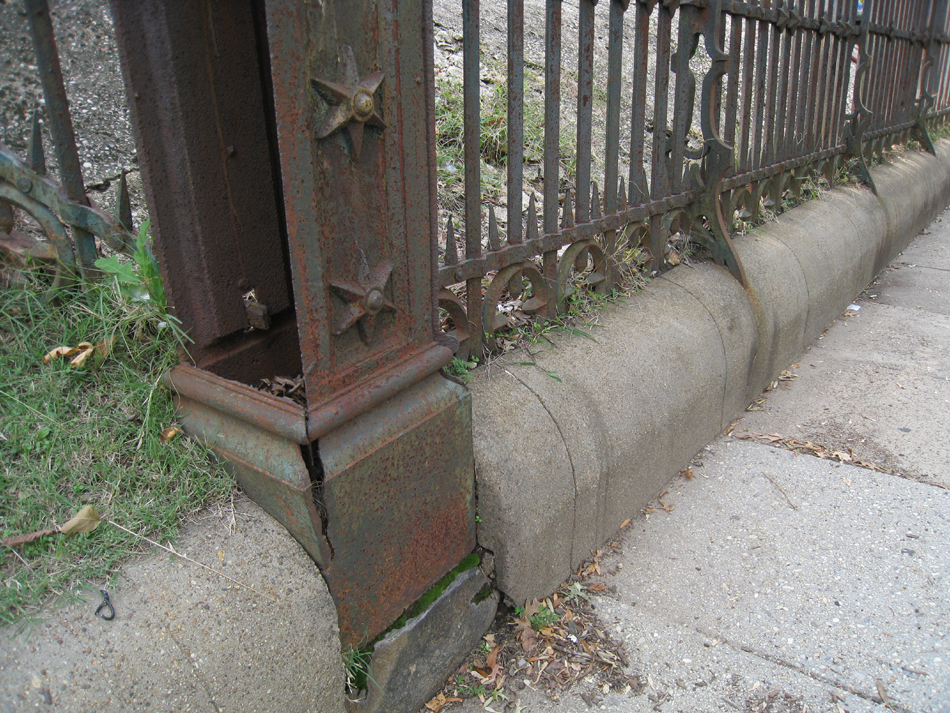 Fence--Detail--Removal of cement from bottom of fence on Pennsylvania Ave. side (northeast corner of fence)