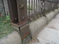 Fence--Detail--Removal of cement from bottom of fence on Pennsylvania Ave. side (northeast corner of fence) - October 19, 2010