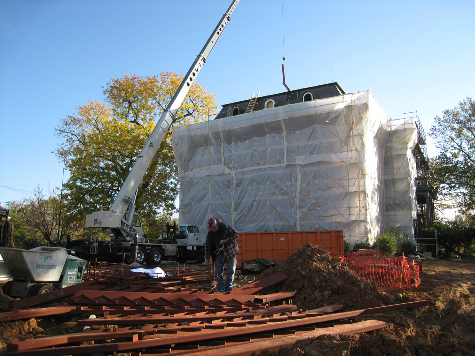 Miscellaneous--Stair elements being lifted into building through the elevator shaft