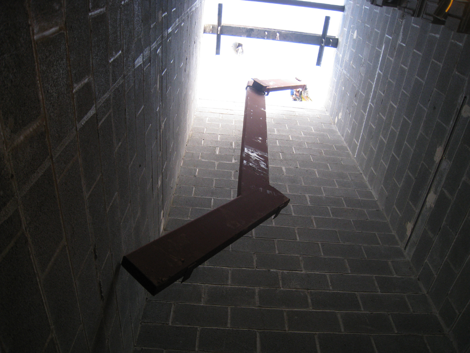 Miscellaneous--Stair elements being lifted into building through the elevator shaft on the second floor