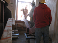 Second Floor--Lifting the parts for the east staircase into the building (through the west side corridor window) - November 19, 2010