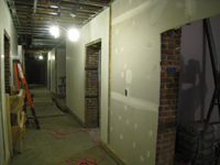 Ground Floor--New concrete floors and drywall in corridor looking east - February 1, 2011