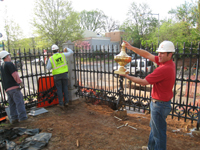 Fence--Looking out toward the corner of Tenth and E Streets SE.  Erik Krupp with model of corner piece - April 20, 2011