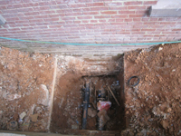Elevation--View of foundation (in brick).  Pipes go under the foundation (not through).  South east side of building--water pipes - April 29, 2011