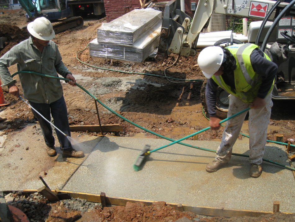 Grounds--Brushing and washing off top layer of concrete to expose small stone - June 10, 2011