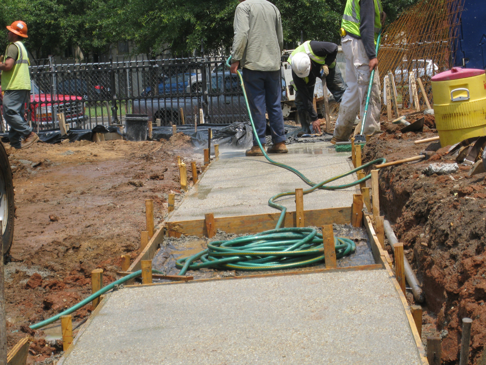 Grounds--Brushing and washing off top layer of concrete to expose small stone - June 10, 2011