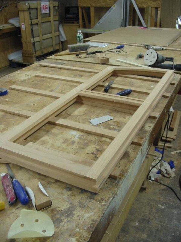 The casement windows on the ground (basement) floor are being completely replaced since the  original windows were destroyed. These sashes were fabricated using Spanish Cedar  and restoration glass.